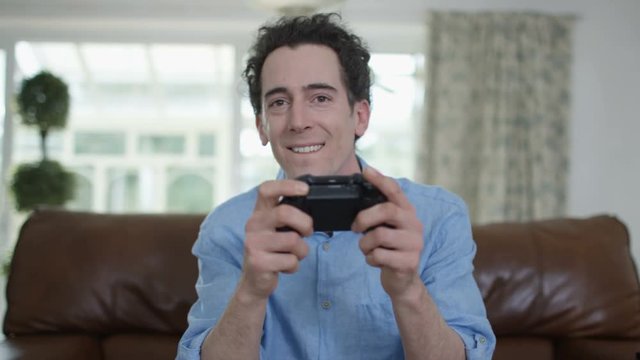  Competitive man playing video games at home, as seen from screen's pov