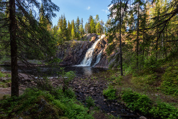 Fototapeta na wymiar Landscape with beautiful waterfall and forest