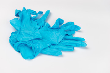 Blue medical gloves after use on white background