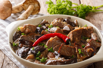 beef stew with wild mushrooms, onion and chili pepper in spicy sauce close-up in a bowl. horizontal