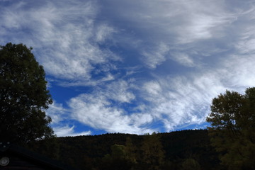 clouds in the sky with shadows of trees in the French Pyrenees. Occitanie in south of France