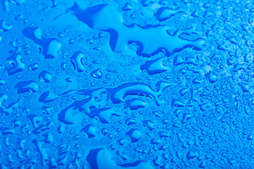 water drop on surface of fresh blue background