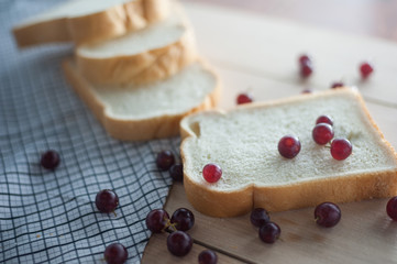 bread with grapes on wood plate side view