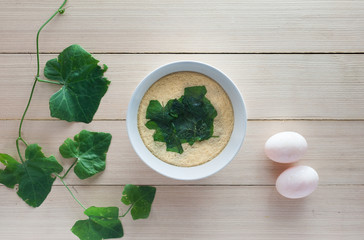 steamed egg with eggs and ivy gourd on wood plate