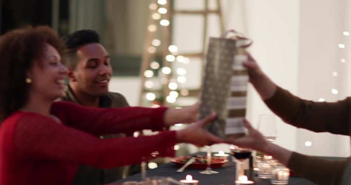 Friends giving a gift of wine at a dinner party