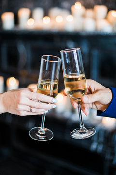 bride and groom holding glasses with champaign