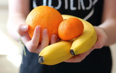 Owoce cytrusowe w dłoniach dziewczyny