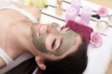 Face Treatment. Woman in Beauty Salon Gets Marine Mask