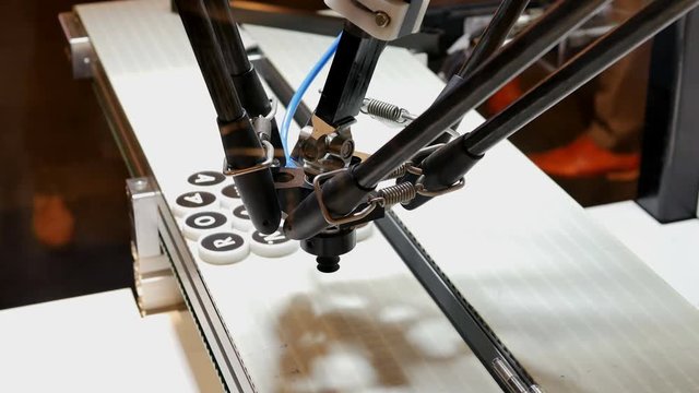 Robot arm places words from letters on a conveyor belt with model driven integrated smart software 