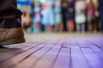 men's foot in the shoes and dance floor