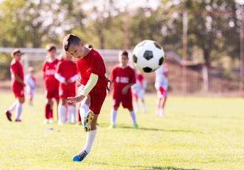 Kids soccer football - young children players match on soccer field