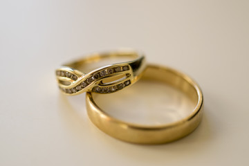 Gold rings macro. Close up photo of a male wedding ring and a female eternity ring