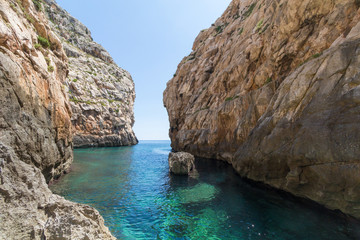 Fototapeta premium Wied Babu, at Wied iz-Zurrieq, azure blue turquoise waters at the bottom of the valley, next to the Blue Grotto, Zurrieq, Malta, May 2017