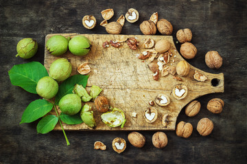 Whole Walnuts and Cleared Black Wooden Background Top view Healthy concept