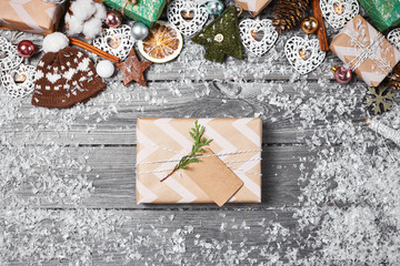 Gift boxes, Christmas decorations and pine cones on gray wooden table. Christmas background. Space for text. Top view.