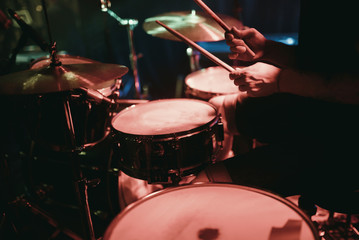 Fototapeta na wymiar Drummer playing his drum kit on concert in club
