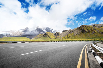 Fototapeta premium empty asphalt road with beautiful snow mountain