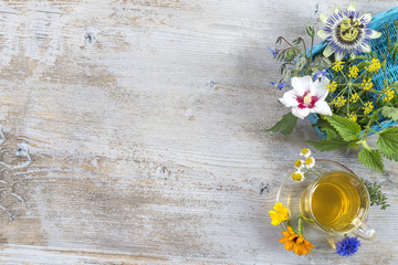 Various dried meadow herbs and herbal tea on wooden table. fresh medicinal plants and in bundle. Preparing medicinal plants for phytotherapyand health promotion