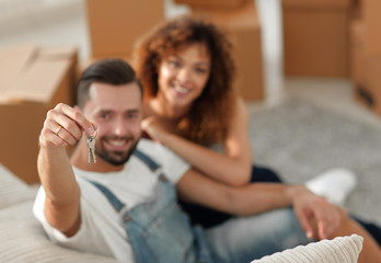 Young couple with a key to a new apartment.