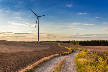 Amazing sunset at countryside with wind turbine in autumn