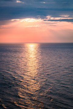 Dynamic dusk over calm ocean in summer