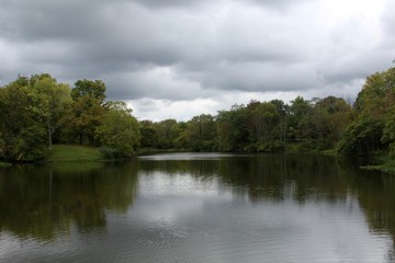 A cloudy day at the lake in the park.