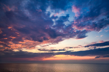 Naklejka na ściany i meble Beautiful sunset over calm sea in summer