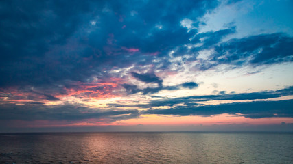 Naklejka na ściany i meble Stunning sunset over calm sea in summer