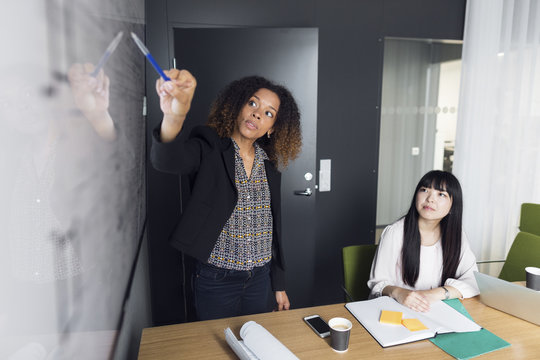 Architect giving presentation to a colleague in office
