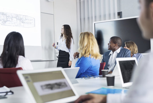 Female architect giving presentation at office meeting