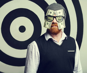 Concept - portrait of a Money Man. A man with glasses. One hundred US Dollars in the eyes. Watch...