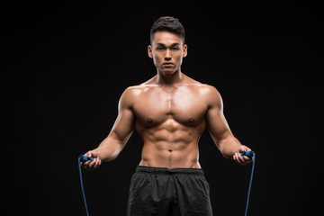 Fototapeta na wymiar muscular man with skipping rope