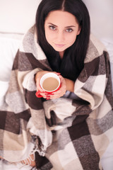 Woman's hand holding a red cup of coffee. With a beautiful winter manicure. Drink, fashion, morning