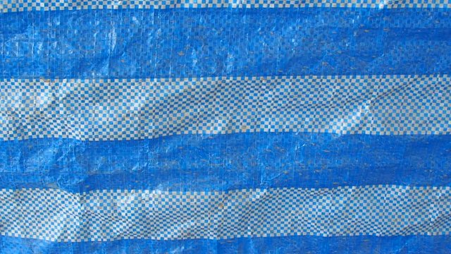 Blowing crease basketry blue striped plastic construction protection canvas background, with small wind breeze