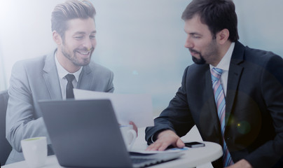 Fototapeta premium Successful business partners are discussing project and smiling.