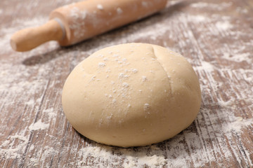 raw dough with rolling pin