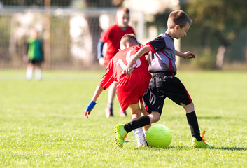 Kids soccer football - young children players match on soccer field