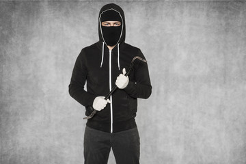 thief ready to work, gloves, crowbar and balaclava