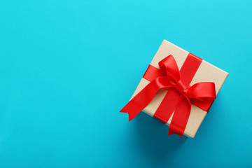 Gift box with ribbon on blue background