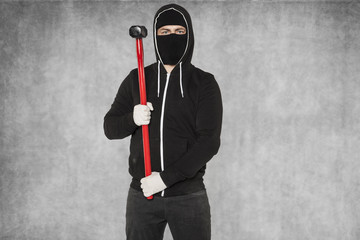 masked man with hammer, copy space