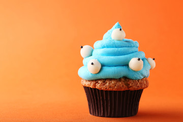 Halloween cupcake on orange background