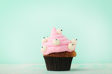 Halloween cupcake on mint background