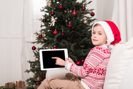 boy pointing at tablet on christmas