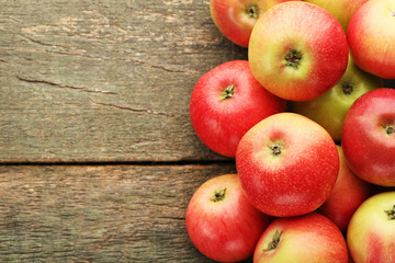 Ripe and sweet apples on wooden table
