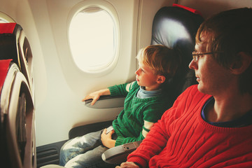 family travel -father and little son in flight