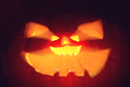 Halloween Pumpkin. Scary glowing smoking monster pumpkin from depths of hell.