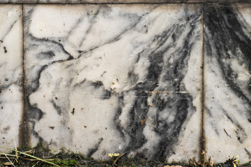 The texture of the brushed stone, marble. Different shades of gray with splotches, stripes, lines. Close-up