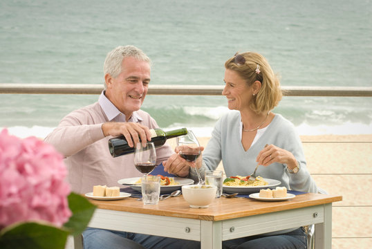 Couple Dining At Seaside Restaurant