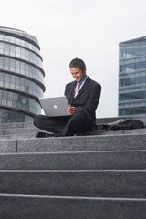 Business man with laptop outside