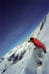 Male in action on a snowboard © Image Source RF